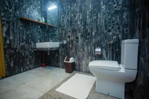 a bathroom with a toilet and a sink at Villa Nine84 Mirissa in Matara