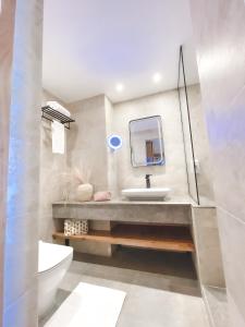 a bathroom with a sink and a toilet at The Breakers Diving and Surfing Lodge Soma Bay in Hurghada