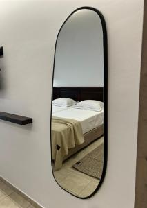 a mirror on a wall next to a bed at Albatros Spa & Resort Hotel in Hersonissos