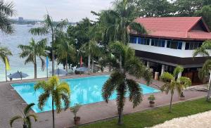 a resort with a large swimming pool next to the water at Samal Sands and Shores in Magamomo