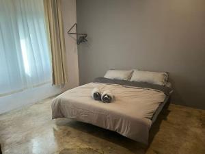 a bedroom with a bed with two cameras on it at JW Homestay (ShopHouse Lv2) in Kudat