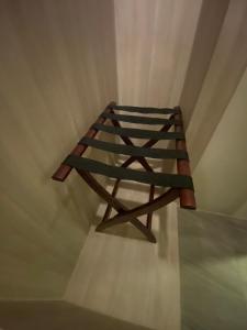 a wooden stool sitting on top of a floor at Gold Orchid Bangkok Hotel in Bangkok