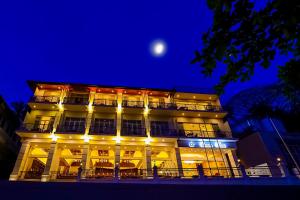 un edificio iluminado con una luna en el cielo en Devon Rest en Kandy