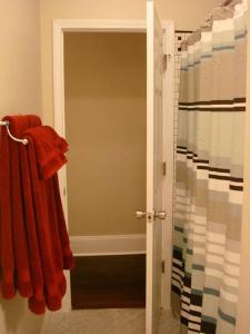 a bathroom with an open door to a shower at St Louis House near Arch and Ballpark Village in Soulard