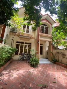 a house with two bikes parked in front of it at Entire Town House in Chroy Changva area in Phnom Penh