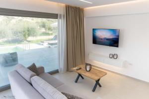 a living room with a couch and a table at Anthelia Luxury Villas in Karpathos Town