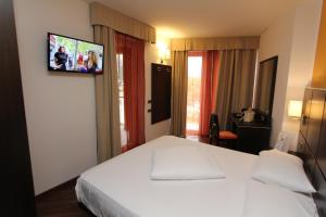 Postel nebo postele na pokoji v ubytování Hotel Villa Rosa