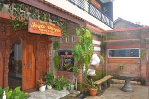 a restaurant with a sign on the side of a building at OYO 93736 Homestay Joglo Dephis Syariah in Magelang