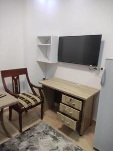 a room with a desk with a tv and a chair at Hurghada City Apartment 3 in Hurghada
