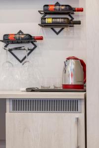 a shelf with wine glasses and a toaster on a counter at Scaramantico Rooms in Naples