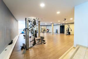 a gym with treadmills and ellipticals in a room at Oceanis Hotel in Kavála