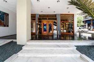 a lobby of a building with glass doors at Oceanis Hotel in Kavála