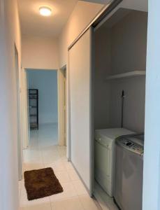 a laundry room with a washer and dryer at The Trails Kampar in Kampong Malim Nawar