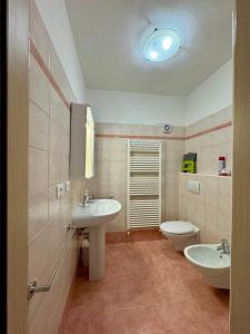 a bathroom with two sinks and a toilet at 1Dest - Waterfall & Pool with Garden in Riva del Garda +23 photos