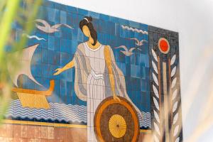 a painting of a woman on a tile wall at Oceanis Hotel in Kavála