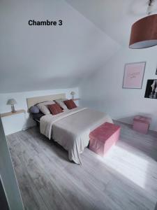 a bedroom with a large bed with red pillows at Maison avec Borne de recharge in Rolampont