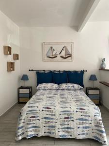 a bedroom with a large bed with blue pillows at Cà Lea,2 Minuti dalla Spiaggia di Monterosso in Monterosso al Mare