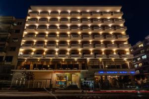 a building with lights on top of it at Oceanis Hotel in Kavála +37 photos