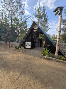 a black building with a sign on it at Lillypond Camp in Elmenteita
