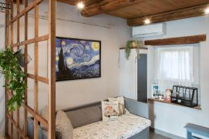 a room with a bed and a painting on the wall at La casetta di Francy, Medea in Medea