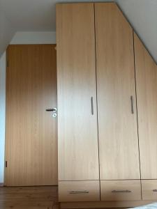 a pair of wooden cabinets in a bedroom at FichtelOase in Nagel