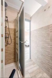 a bathroom with a shower with a glass door at Pedro Happy Studios in Torremolinos