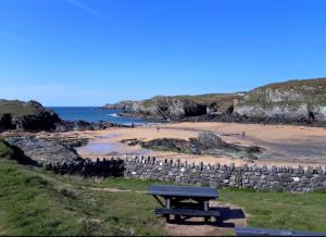 a picnic table sitting on the side of a beach at Holyhead central stay in Holyhead