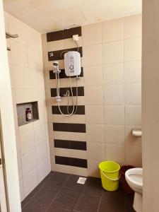 a bathroom with a shower and a toilet at The Trails Kampar in Kampong Malim Nawar