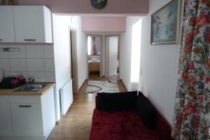 a small kitchen with a sink and a hallway at Apartmenthaus Kestel in Kirchbach