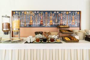 a buffet with bread and other food on a counter at Oceanis Hotel in Kavála