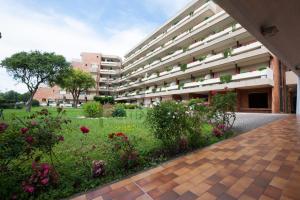 an external view of a building with a garden at Suites Marilia Apartments - Suite Livorno Holiday Home Group in Livorno