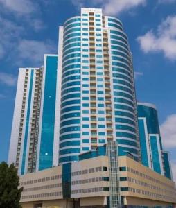 a tall building with many windows in front of it at Orient Tower - Tower C - Ajman city in Ajman 