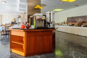 a kitchen with a counter with a coffee maker on it at Oceanis Hotel in Kavála