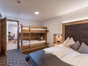 a bedroom with a bed and a bunk bed at Gasthof Schöntal in Oberau