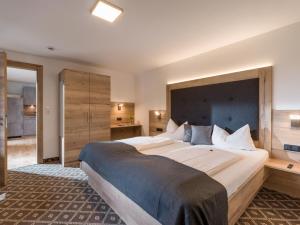 a bedroom with a large bed with a large headboard at Gasthof Schöntal in Oberau