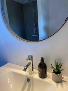 a bathroom sink with a mirror and a soap dispenser at STAY-Atlantic in Skálavík