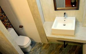 a bathroom with a sink and a toilet at Sundari Eco Village in Habarana