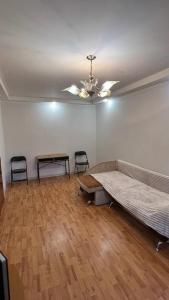 an empty room with a bed and two chairs at Obolonskiy Prospekt Apartments 16Є in Kyiv