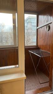 a screened in porch with a window and a cage at Obolonskiy Prospekt Apartments 16Є in Kyiv