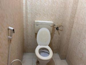 a small bathroom with a toilet and a shower at M K Raja Hotel in Kelambākkam