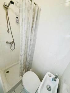 a small bathroom with a toilet and a sink at Central studio AC & balcony in Nice