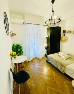a bedroom with a bed and a table and a desk at Central studio AC & balcony in Nice