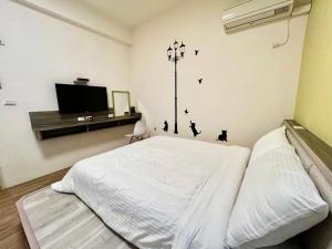 澎湖菊舍民宿一館客房内的一张或多张床位