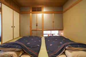a large bed in a room with a window at おやど紀伊国屋中町 in Asahimachi +52 photos