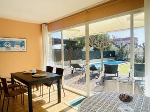 a dining room with a table and a patio at Villa Sol i Mar by Costabravaway in Platja  d'Aro