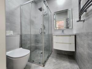 a bathroom with a shower and a toilet and a sink at Park Azure Best apartment in Baku