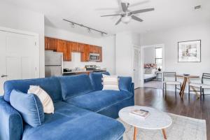a living room with a blue couch and a table at CozySuites Music Row Bold 1BR w free parking in Nashville +34 photos