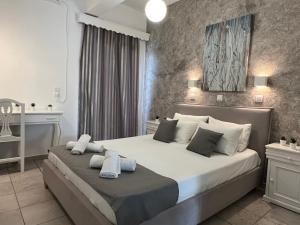 a bedroom with a large bed with towels on it at Villa Pavlina in Karterados