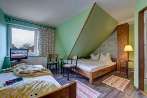 a room with two beds and a window at Apartmany Na Skle Malovane in Liptovská Kokava