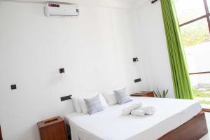 Postel nebo postele na pokoji v ubytování Randon Resort Mirissa